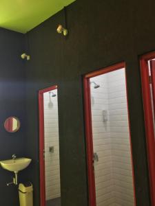 a bathroom with two mirrors and a sink at Bandung Hostel in Bandung