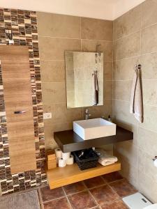 a bathroom with a sink and a mirror at Villa Consuelo - Quiet Location Close to Resorts in Buzanada