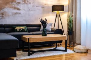 a living room with a couch and a table at Apartments Tomy in Sutivan