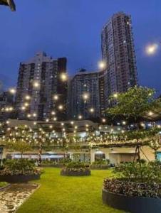 a city at night with tall buildings and lights at Aussie Shack - 2BR Modern Condo with Skyline View in Manila