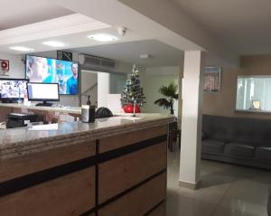 a lobby with a christmas tree on a counter at Hotel Estrela Mares in Três Marias