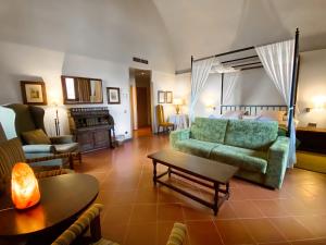 salon z zieloną kanapą i stołem w obiekcie Parador de Cardona w mieście Cardona