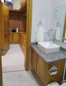 a bathroom with a sink and a mirror at Villa en Plantation, Puerto Plata in Muñoz