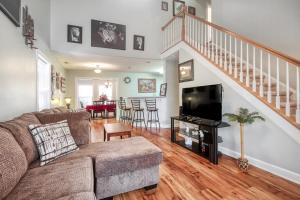 a living room with a couch and a tv at Palm Oaks Estate in Myrtle Beach