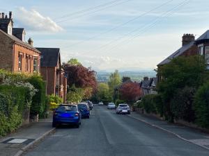 a blue car parked on a street in a town at North View B&B in Penrith