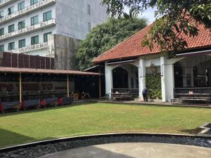 a building with a lawn in front of a building at Bandung Hostel in Bandung