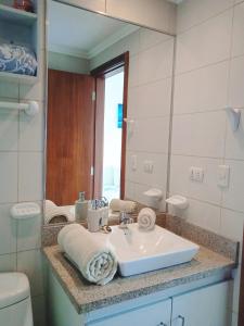 a bathroom with a sink and a mirror at Apartments Puerto Santa Ana in Guayaquil