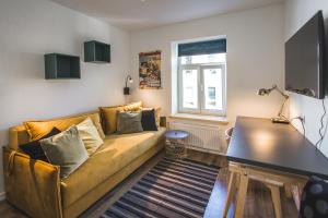 a living room with a couch and a table at Bearsleys Knights Apartments in Rīga