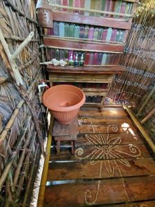 a bathroom with a large bowl on a wooden floor at Derek's Place Eco-Lodge in Little Corn Island +31 photos