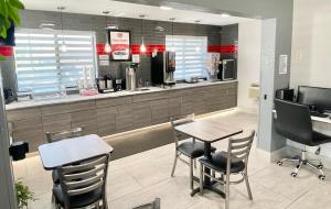 a restaurant with a table and chairs and a counter at Econo Lodge Cartersville-Emerson Lake Point in Cartersville