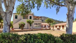 an image of a house with mountains in the background at Podere Il Ritorno in Portoferraio