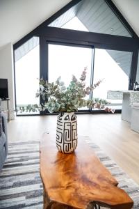 a vase sitting on top of a wooden table at Ocean View - Bracklesham Bay in Chichester