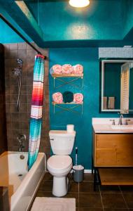 a blue bathroom with a toilet and a sink at The Three Keys duplex in Sedona