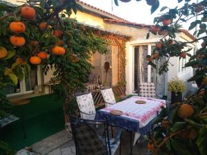 a table and chairs on a patio with oranges at Wellness Apartments Ra in Primošten