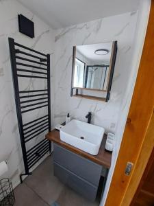 a bathroom with a sink and a mirror at NC500 - Modern croft house at Handa in Scourie