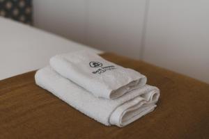 een stapel handdoeken bovenop een tafel bij Best Houses 25 - Seaside Retreat in Peniche