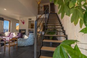 a staircase in a house with a living room at Chalet le 1000 Thabor in Valmeinier