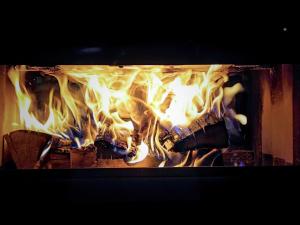 a fire in a fireplace with flames in it at Chalet le 1000 Thabor in Valmeinier