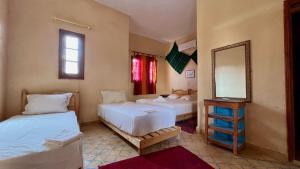 Postel nebo postele na pokoji v ubytování Hotel Riad Oasis