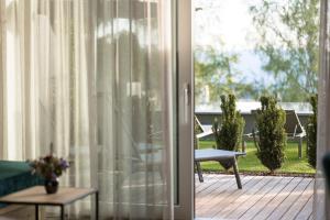 una puerta corredera de cristal que conduce a un patio con mesa en Hotel Salten en Avelengo