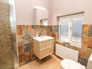 a bathroom with a sink and a mirror at Glenhurst in Dronfield +32 photos