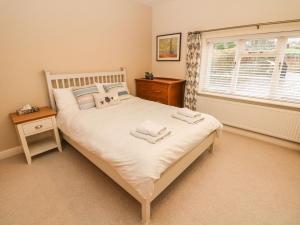a bedroom with a bed with two towels on it at Glenhurst in Dronfield