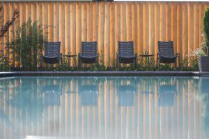 a group of chairs sitting in front of a fence at Hotel Salten in Avelengo