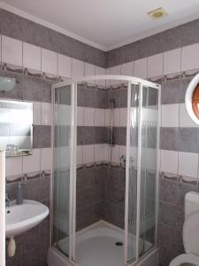 a bathroom with a shower and a sink at Medgyaszay Panzió in Nagykanizsa