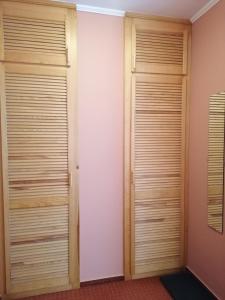 two closets with wooden doors in a room at Medgyaszay Panzió in Nagykanizsa