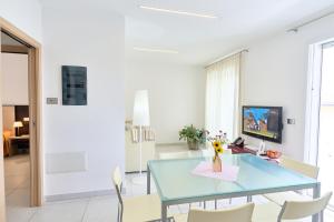 a dining room with a blue table and chairs at JUST SUITES in Cervia