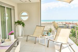 a dining room with a view of the ocean at JUST SUITES in Cervia