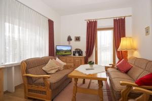 a living room with two couches and a coffee table at Haus Regner in Reit im Winkl