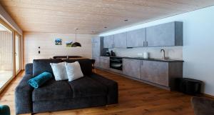 a living room with a couch and a kitchen at Vergalda Apartments in Gargellen