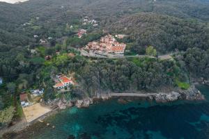 an aerial view of a house on a hill next to the water at La Paolina Vista Mare e Natura in Marciana Marina