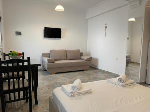 a living room with a couch and a table at Levend Apartments in Ksamil