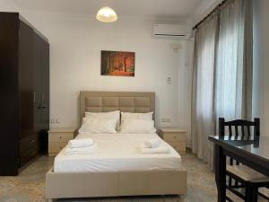 a bedroom with a bed with two towels on it at Levend Apartments in Ksamil