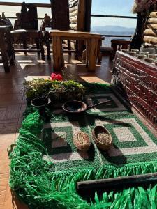a table with a green table cloth and some bowls at Panoramic View Hotel in Lalībela