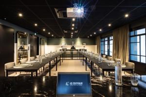 a conference room with tables and chairs and a laptop on a table at Le Celtique & Spa in Carnac +37 photos