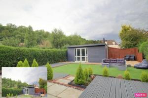 a view of a garden with a house at Luxurious 4 Bedroom Detached Family Home in Burton Joyce