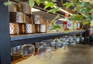 a row of glass jars on a shelf with plants at Hotel 10 São Leopoldo in São Leopoldo