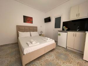 a bedroom with a bed with two towels on it at Levend Apartments in Ksamil