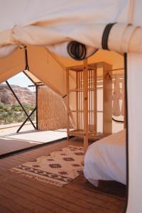 a bedroom with a bed and a bed frame with a bed sqor at 26North Glamping in Al Ula