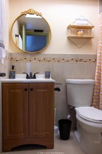 a bathroom with a sink and a mirror at The Green Door Bungalow in Naples