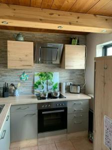 a kitchen with a stove and a microwave at Ferienhaus für 7 Pers./Schlei in Oersberg