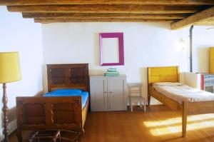 A bed or beds in a room at La Casa Altrui- Camere e Zona relax con Giardino