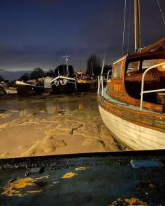 a group of boats sitting in the water at Toosey Lass - St Osyth creek in Saint Osyth