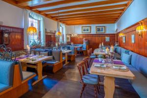 a restaurant with tables and chairs in a room at Hotel Krone in Alzenau