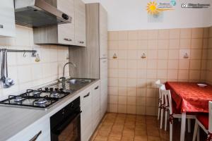 a kitchen with a sink and a stove top oven at Cannotta Beach - Lipari in Terme Vigliatore