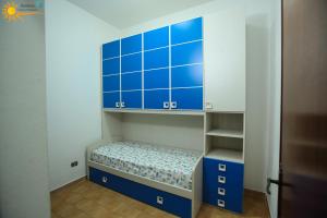 a room with blue cabinets and a small bed at Cannotta Beach - Lipari in Terme Vigliatore
