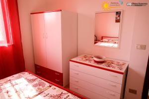 a bedroom with a dresser and a mirror at Cannotta Beach - Lipari in Terme Vigliatore